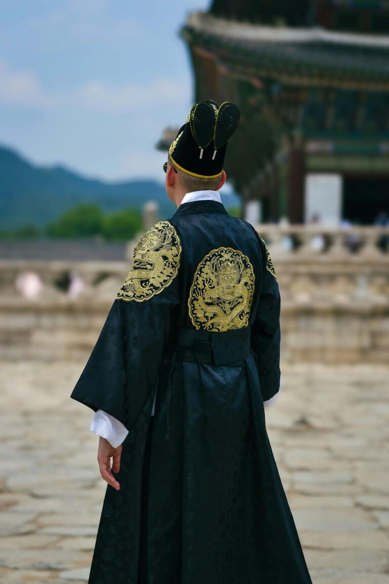 Person in traditional Korean attire at a historic palace in Seoul, South Korea.
